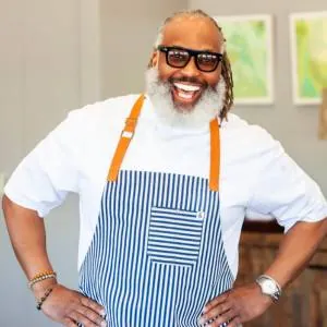 Chef Cliff Rome smiling in a striped apron
