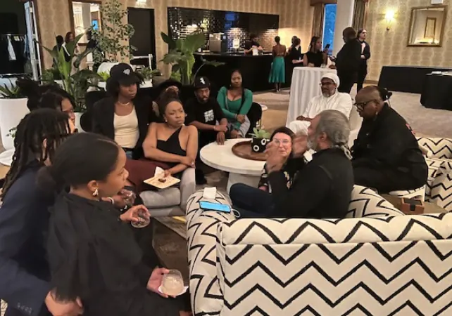 Guests gathered on chevron-patterned sofas at an evening event