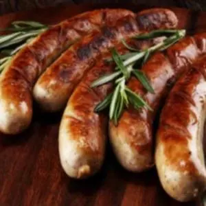 Grilled sausages with a sprig of rosemary